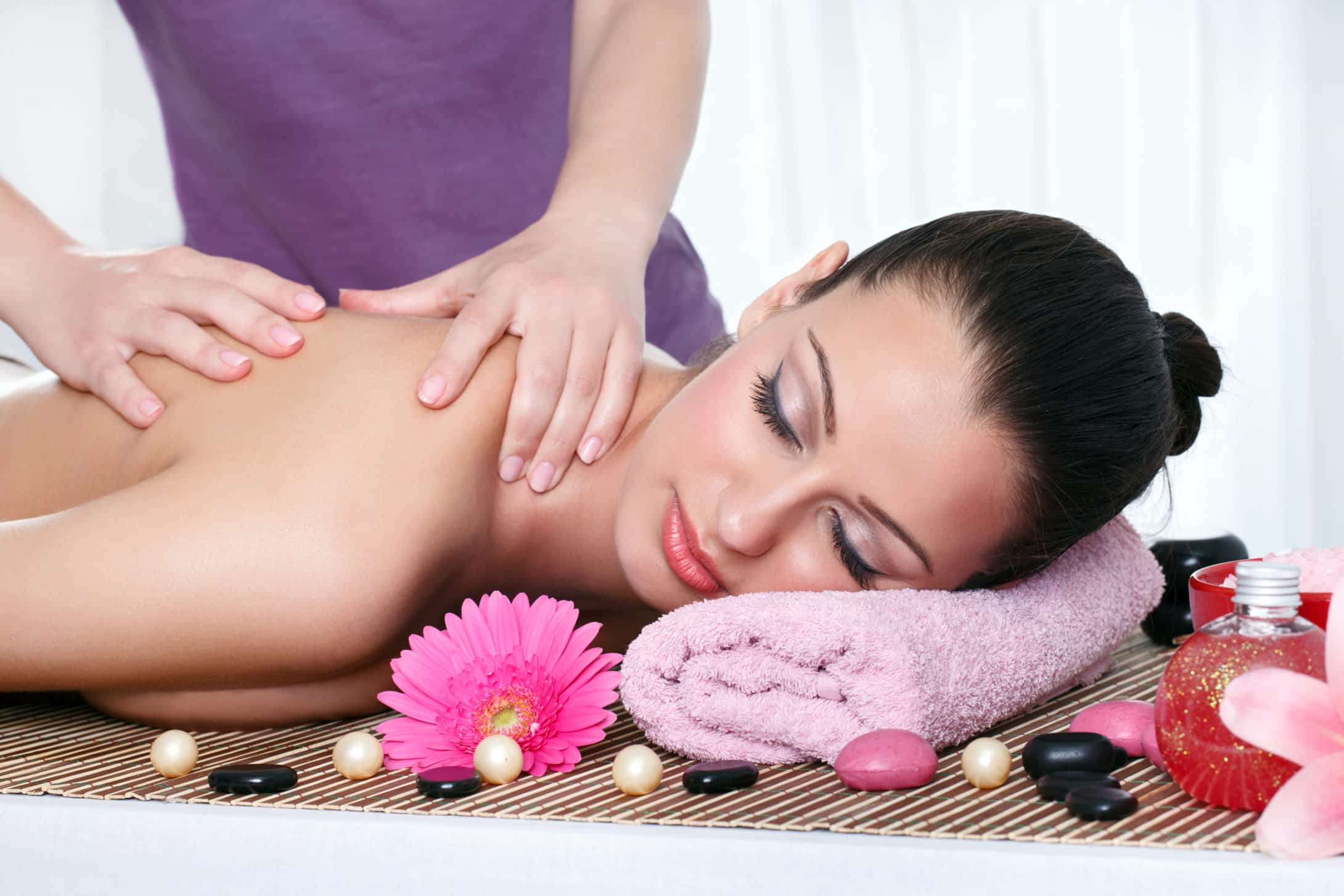 Young female getting a body massage at the day spa